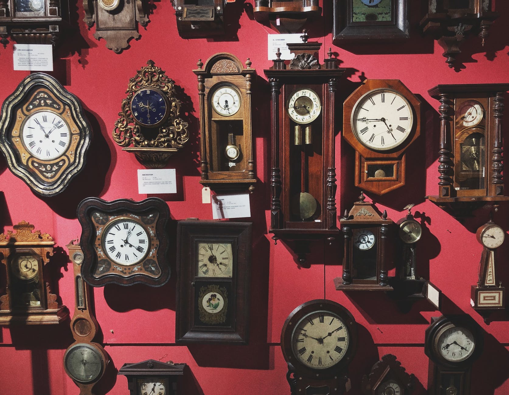 collection of retro wall clocks in antique store